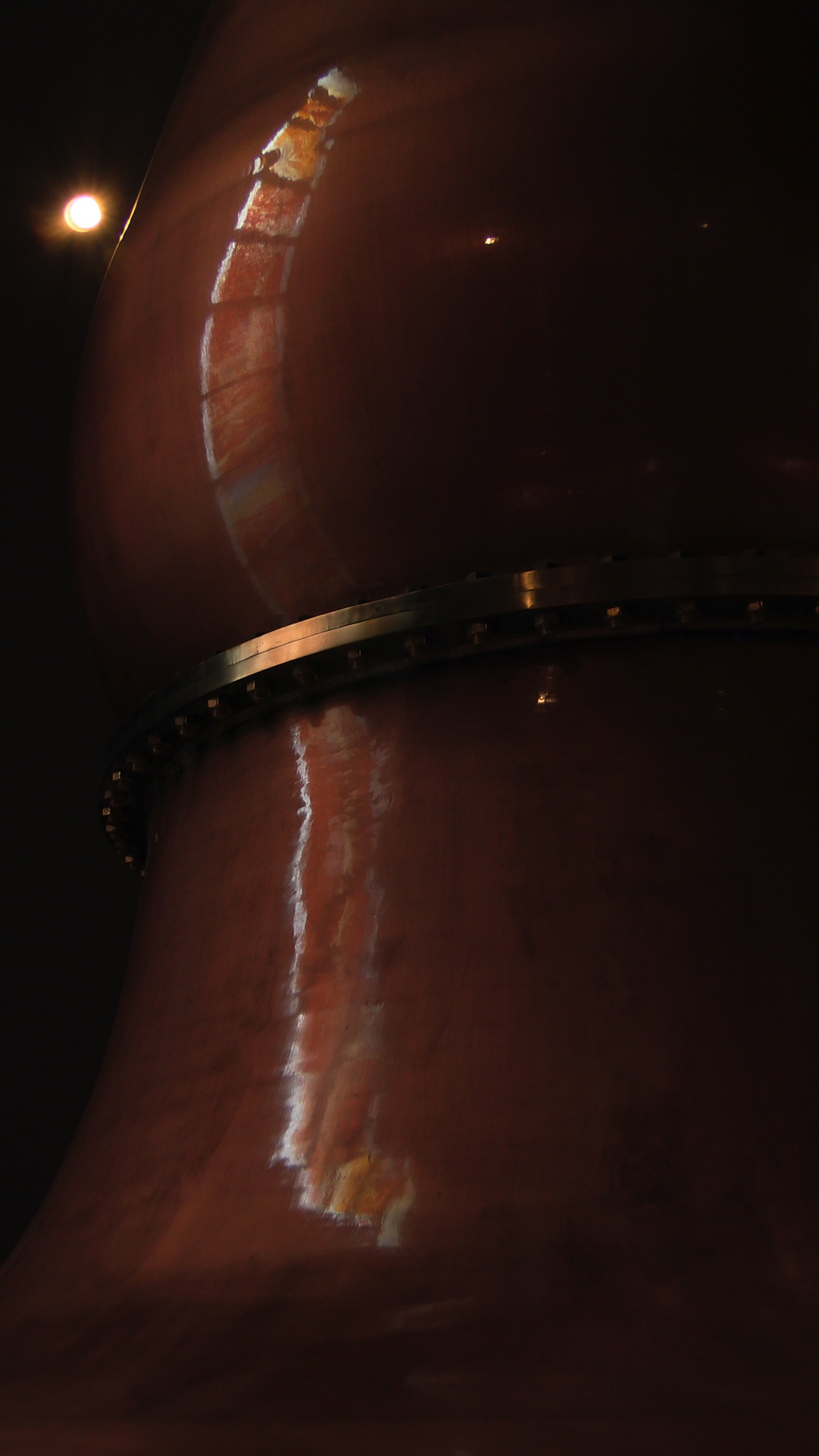 reflection of window in one of the copper stills