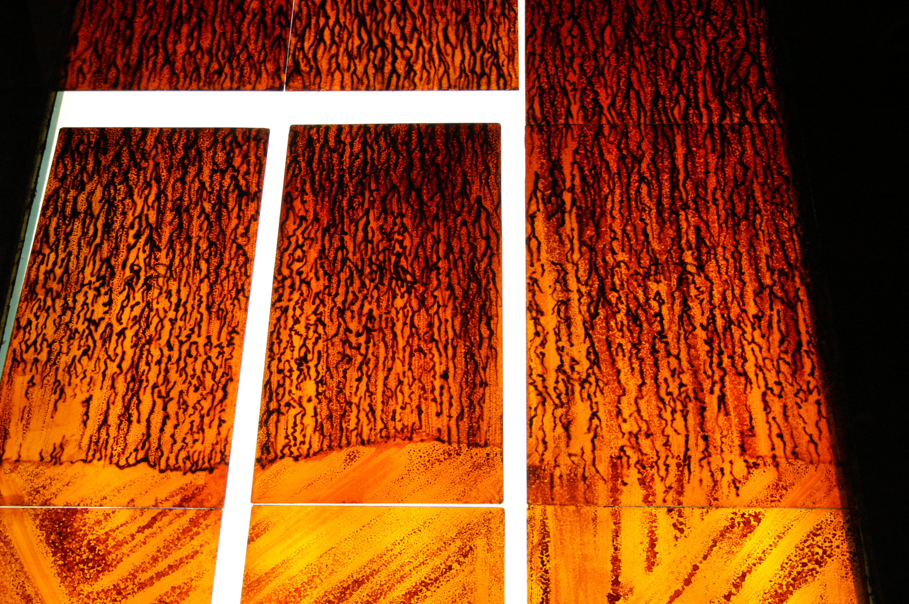 Earth window — deep red flashed glass, volcanic surface