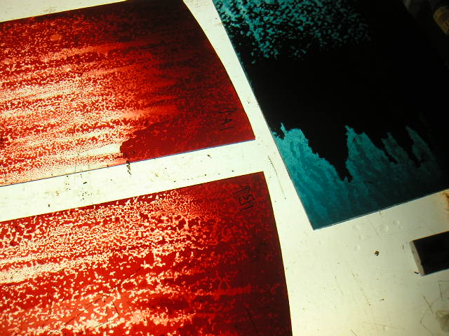 Earth window — deep red flashed glass, volcanic surface